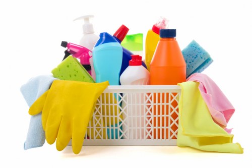 Local upholstery cleaner treating stains on a sofa in Streatham